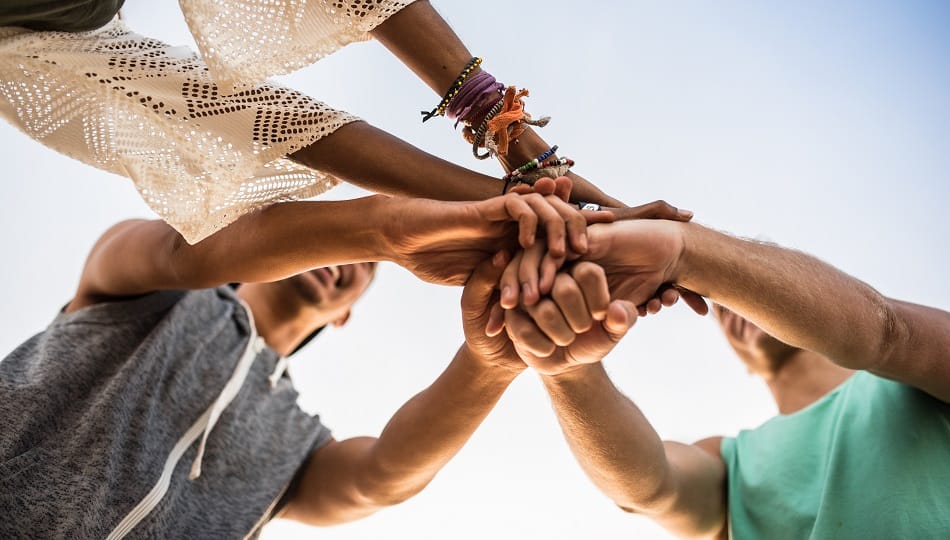 Why Compassion Matters In Life 9 Group of friends putting hands together